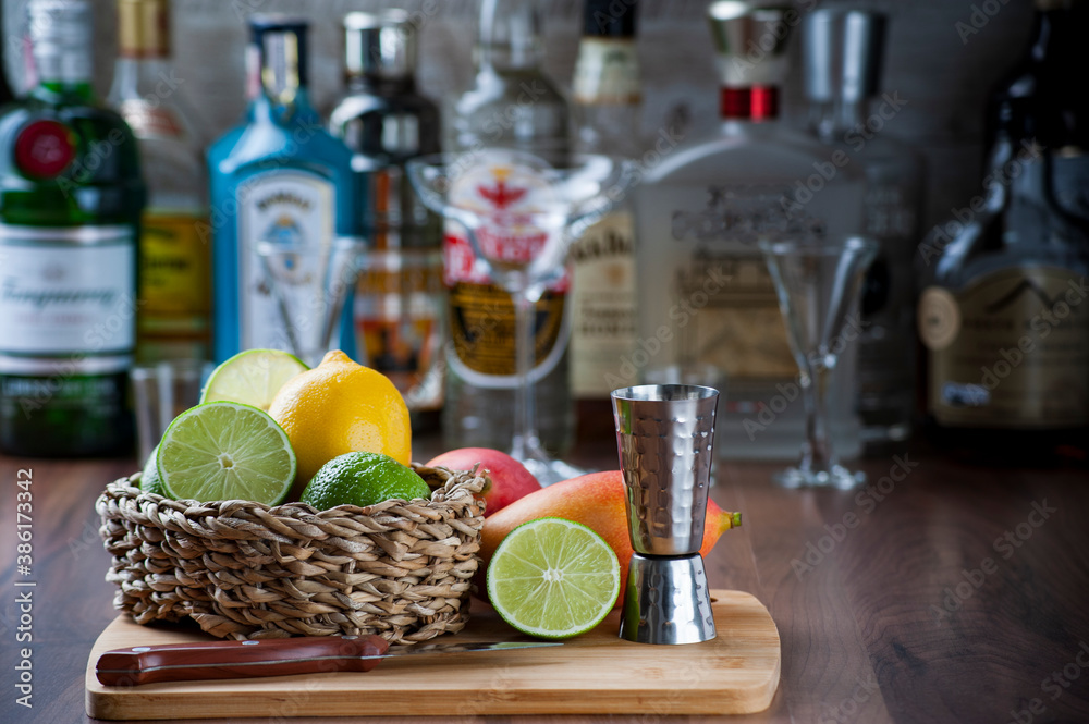 detail of the bar counter with some fruits in a wicker basket, knife and drink dispenser. Blurred background, copy space detail of the bar counter with some fruits in a wicker basket, knife and drink dispenser. Blurred background, copy space