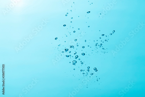 Close up of a water and air bubble on blue background.