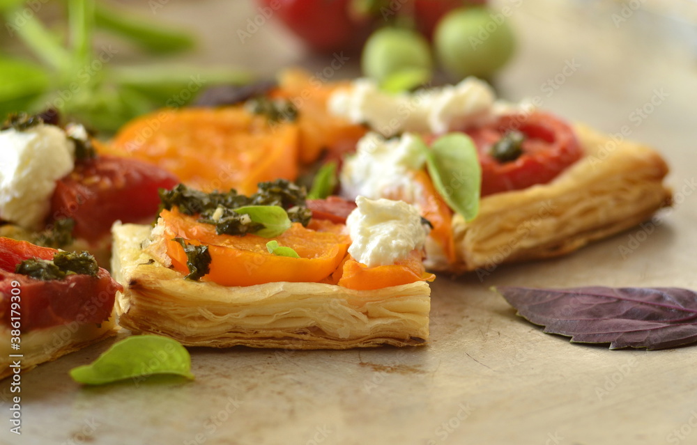 Puff pastry tomato tart with cottage cheese, pesto and basil