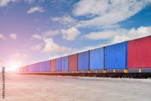 Cargo train platform with freight train Containers on the train shipping inport export on blue sky background.