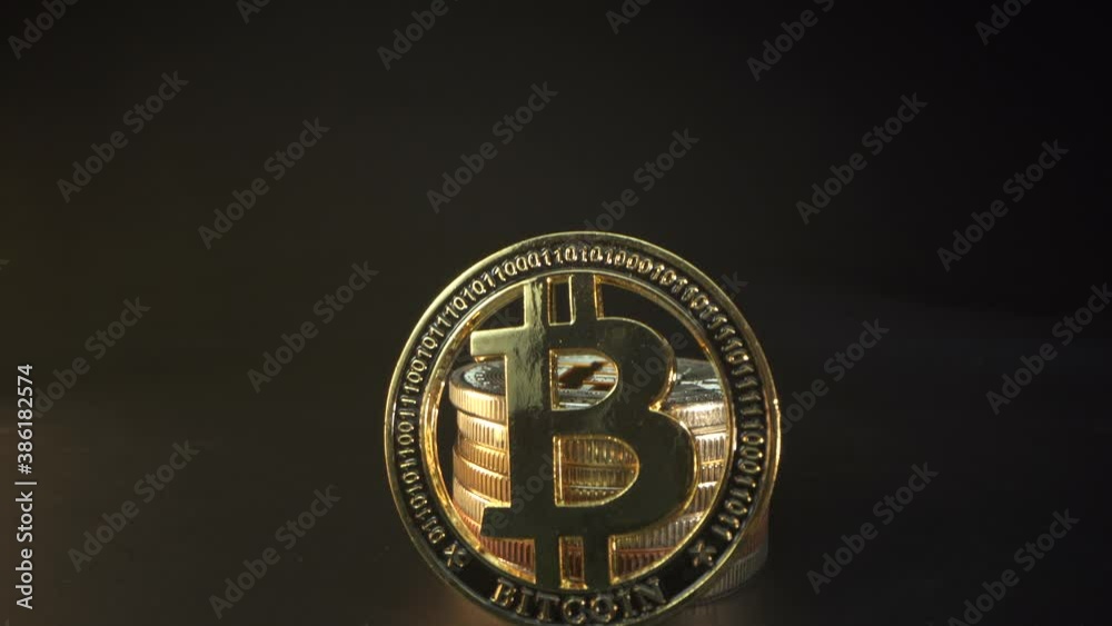Gold bitcoin. Panorama. Close up shot. Blockchain technology. Black background. Many gold crypto coins behind bit coin Gold bitcoin. Panorama. Close up shot. Blockchain technology. Black background. Many gold crypto coins behind bit coin