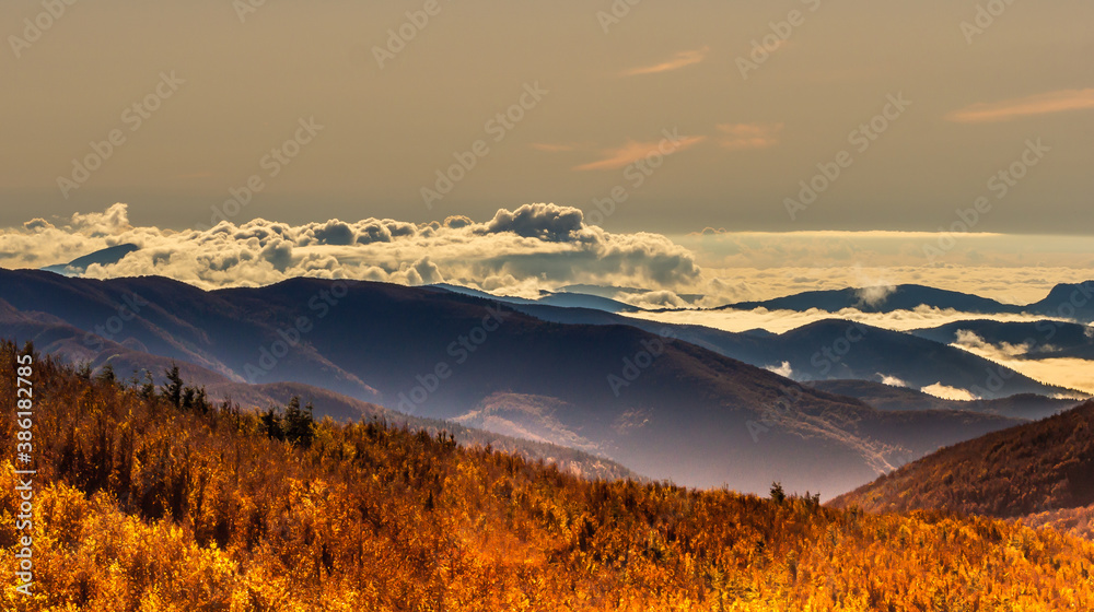 The low-set clouds surrounding the mountain peaks create the illusion of sea waves crashing against islands.