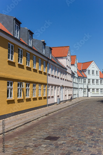 Cobblestoned street with historic houses in Ribe, Denmark © venemama