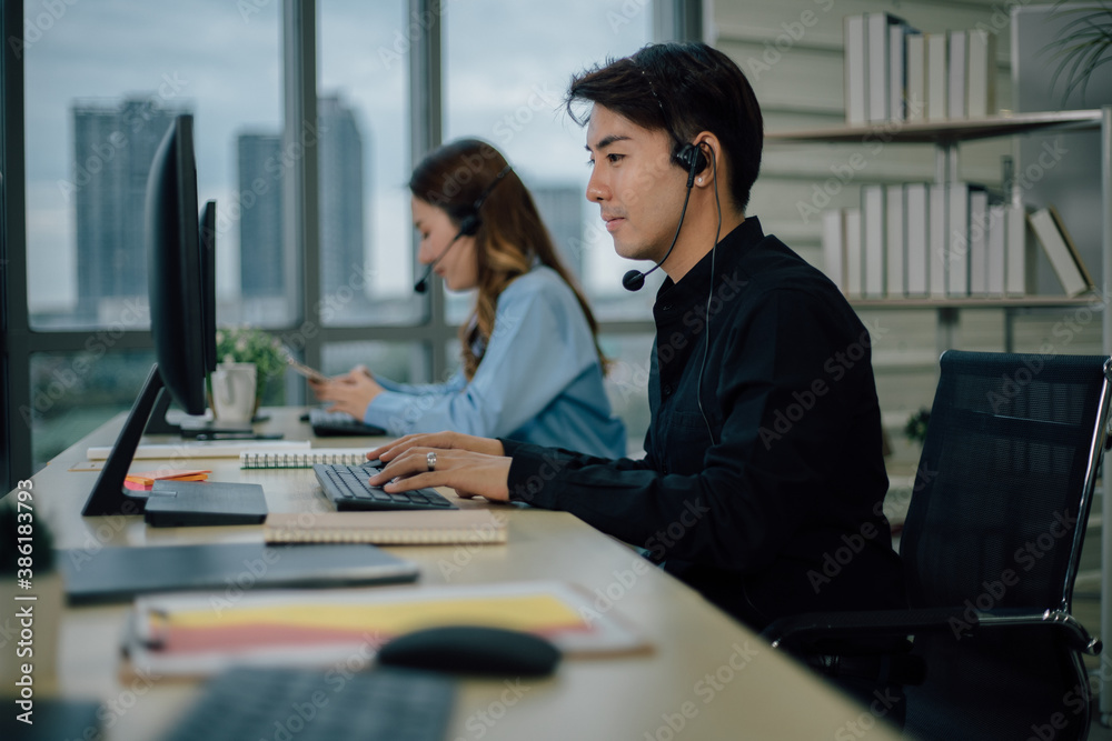 Asian customer support team with headset working at office. Asian customer support team with headset working at office.