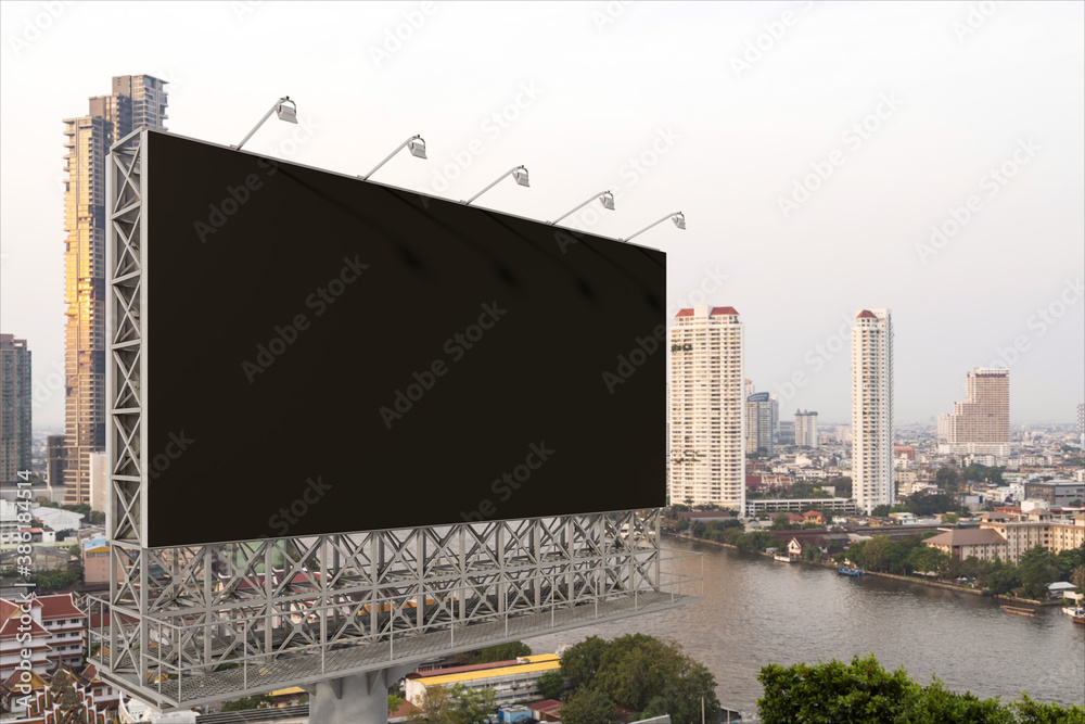 Blank black road billboard with Bangkok cityscape background at day time. Street advertising poster, mock up, 3D rendering. Side view. The concept of marketing communication to promote or sell idea. Blank black road billboard with Bangkok cityscape background at day time. Street advertising poster, mock up, 3D rendering. Side view. The concept of marketing communication to promote or sell idea.