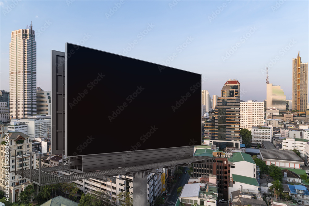 Blank black road billboard with Bangkok cityscape background at day time. Street advertising poster, mock up, 3D rendering. Side view. The concept of marketing communication to promote or sell idea. Blank black road billboard with Bangkok cityscape background at day time. Street advertising poster, mock up, 3D rendering. Side view. The concept of marketing communication to promote or sell idea.