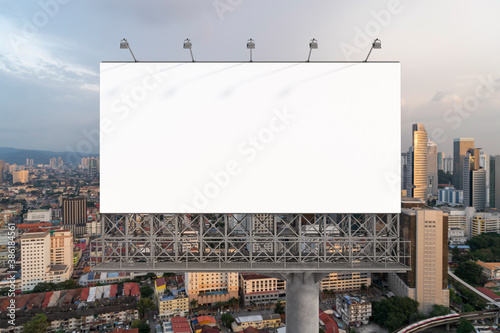 Canvas Print Blank white road billboard with Kuala Lumpur cityscape background at sunset