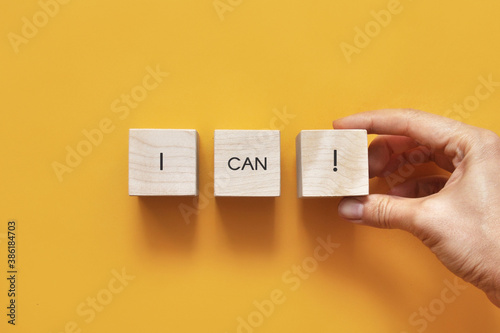 Phrase: I can! on wooden cubes.