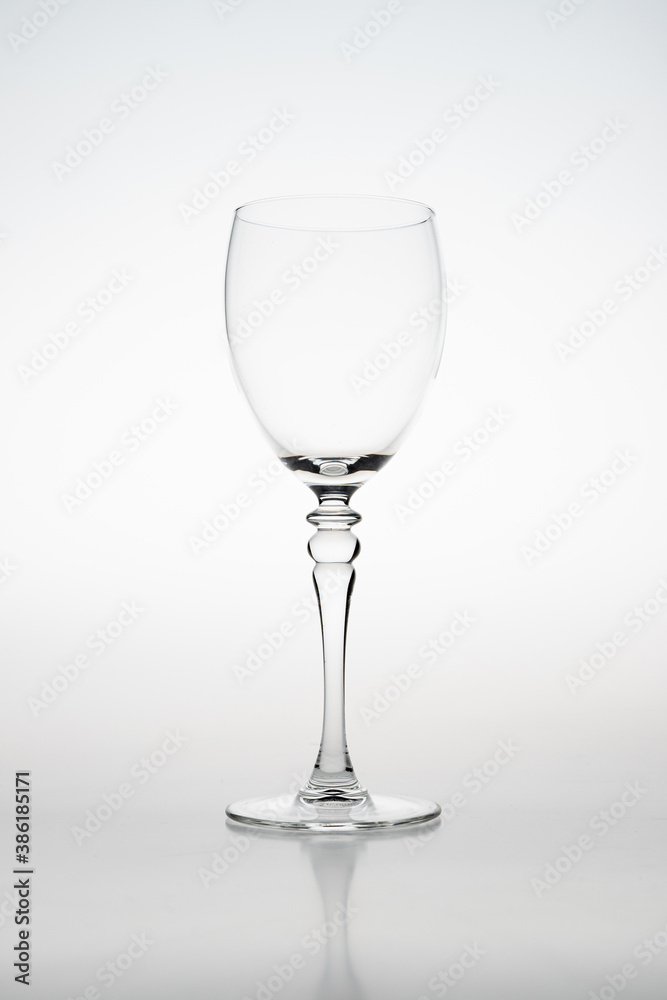High key studio image of a wine glass with a white background. The silhouette of the glass is lightning up due to flash light High key studio image of a wine glass with a white background. The silhouette of the glass is lightning up due to flash light