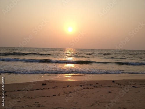 Sunset at the beach with a reflection on water