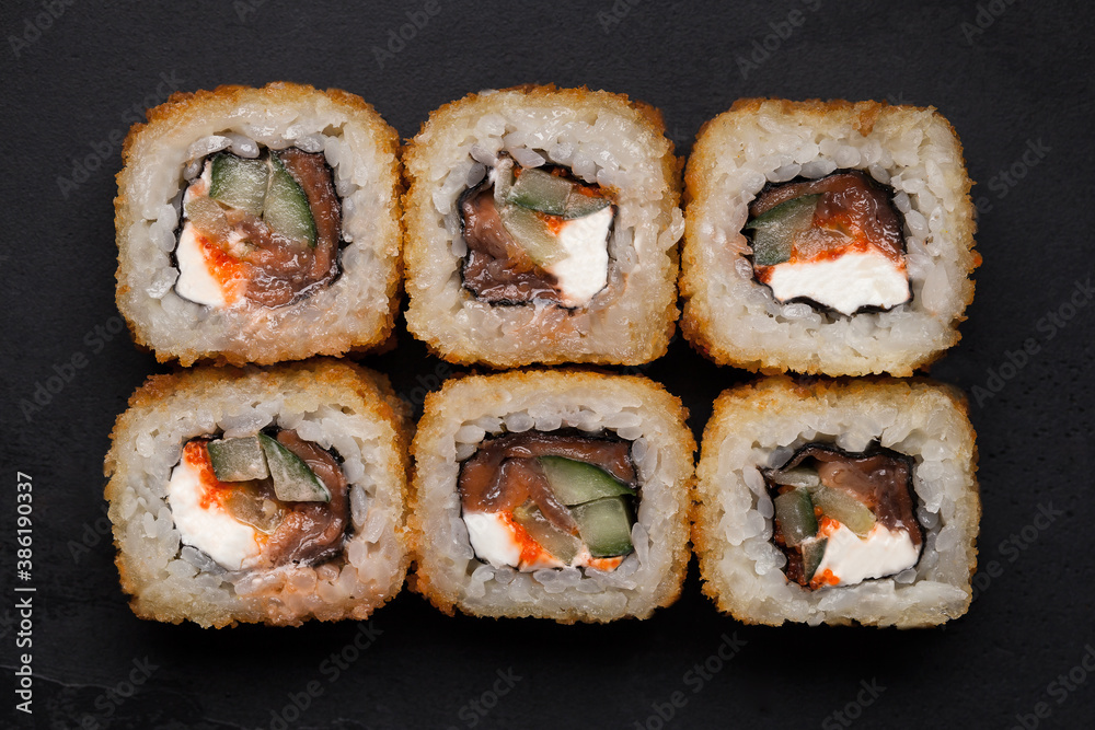 Sushi and rolls. Rolls for the Asian menu.On a black background. Raw fish and rice. Shrimp, salmon, squid, caviar Sushi and rolls. Rolls for the Asian menu.On a black background. Raw fish and rice. Shrimp, salmon, squid, caviar