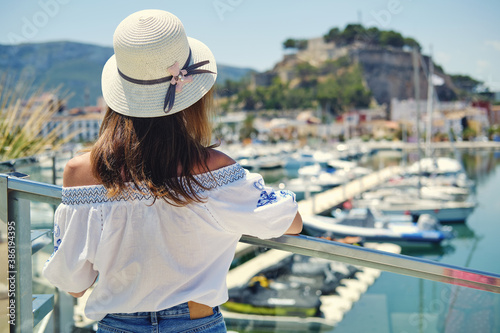 Rear view woman wear hat pose on Denia castle background. Spain photo