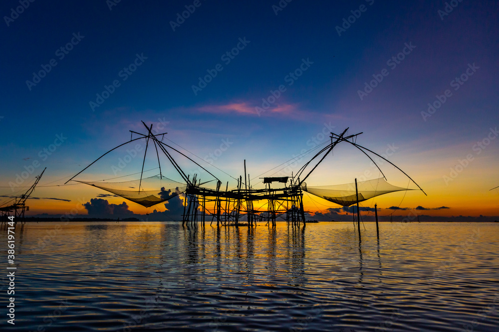 Chinese fish nets during sunrise in Phatthalung province, Thailand Chinese fish nets during sunrise in Phatthalung province, Thailand