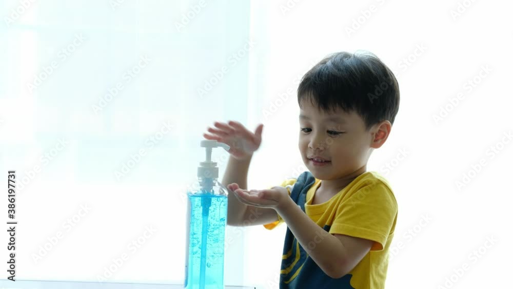 Little boy washing hands with alcohol gel. Virus protection concept. Copy space. Little boy washing hands with alcohol gel. Virus protection concept. Copy space.