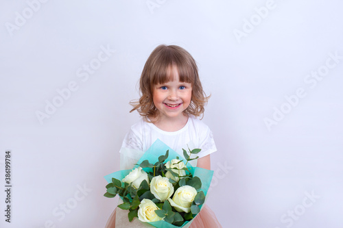 Beautiful and happy girl holding a bouquet of flowers.