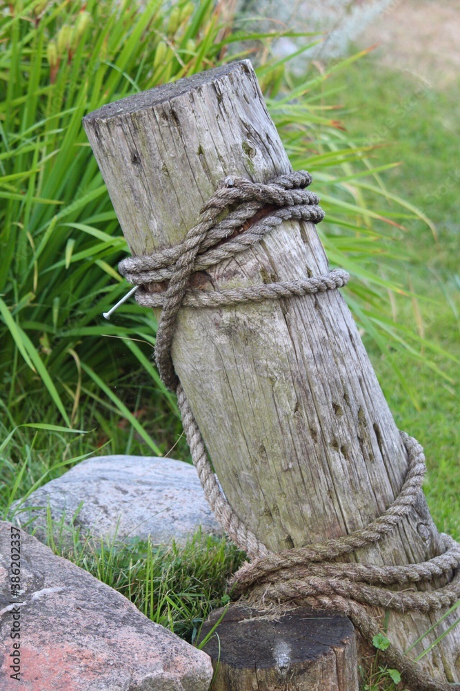 Fototapeta premium tie up post with rope at marina.