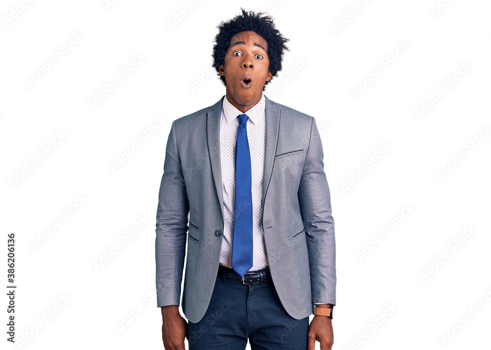 Handsome african american man with afro hair wearing business jacket afraid and shocked with surprise and amazed expression, fear and excited face. Handsome african american man with afro hair wearing business jacket afraid and shocked with surprise and amazed expression, fear and excited face.