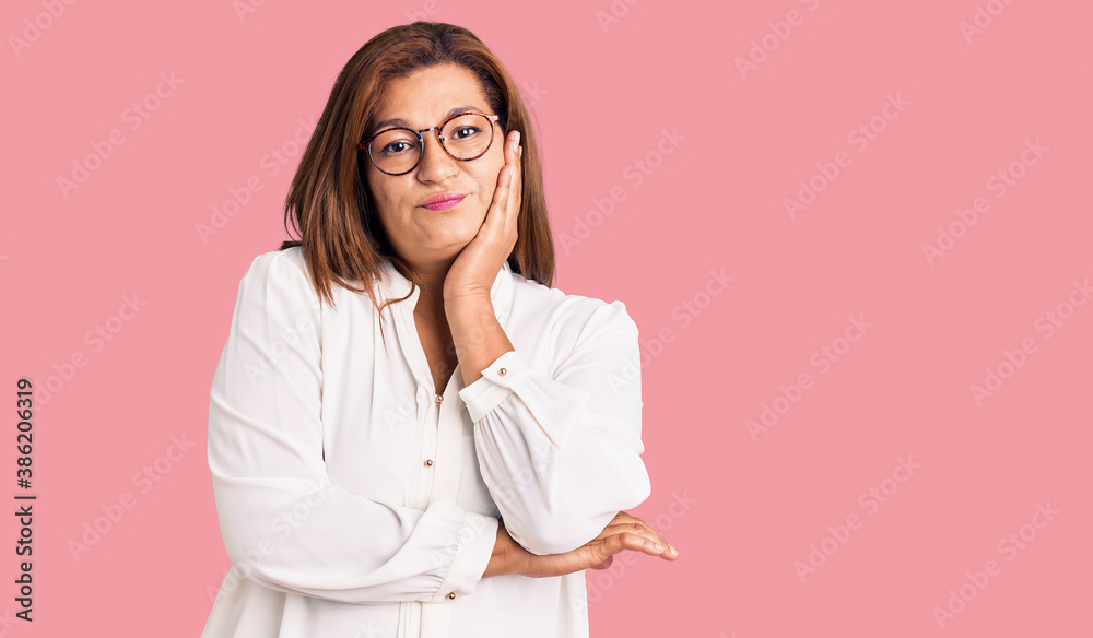 Middle age latin woman wearing casual clothes and glasses thinking looking tired and bored with depression problems with crossed arms. Middle age latin woman wearing casual clothes and glasses thinking looking tired and bored with depression problems with crossed arms.