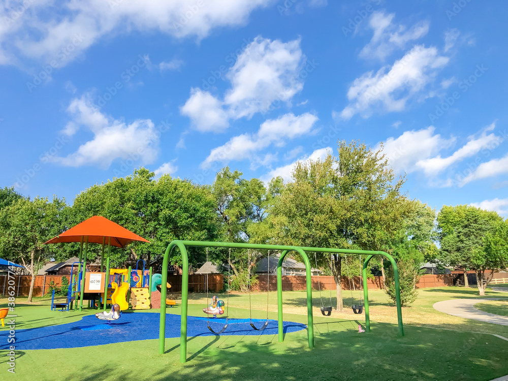 Residential area playground with sun shade sails and artificial grass in Flower Mound, Texas, USA Residential area playground with sun shade sails and artificial grass in Flower Mound, Texas, USA