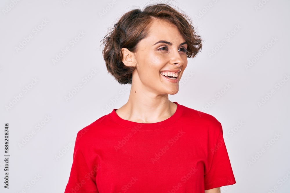 Young hispanic woman wearing casual clothes looking to side, relax profile pose with natural face and confident smile. Young hispanic woman wearing casual clothes looking to side, relax profile pose with natural face and confident smile.