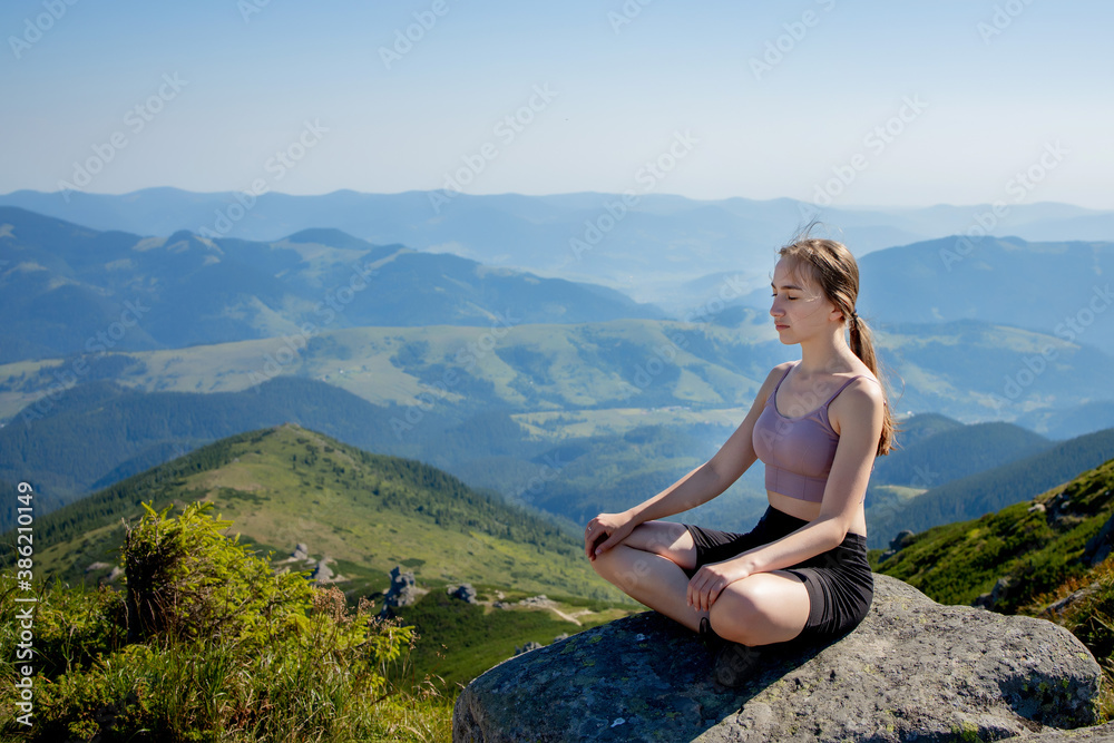 Yoga, Meditation. Woman balanced, practicing meditation and zen energy yoga in mountains. Girl doing fitness exercise sport outdoors in morning. Healthy lifestyle concept.