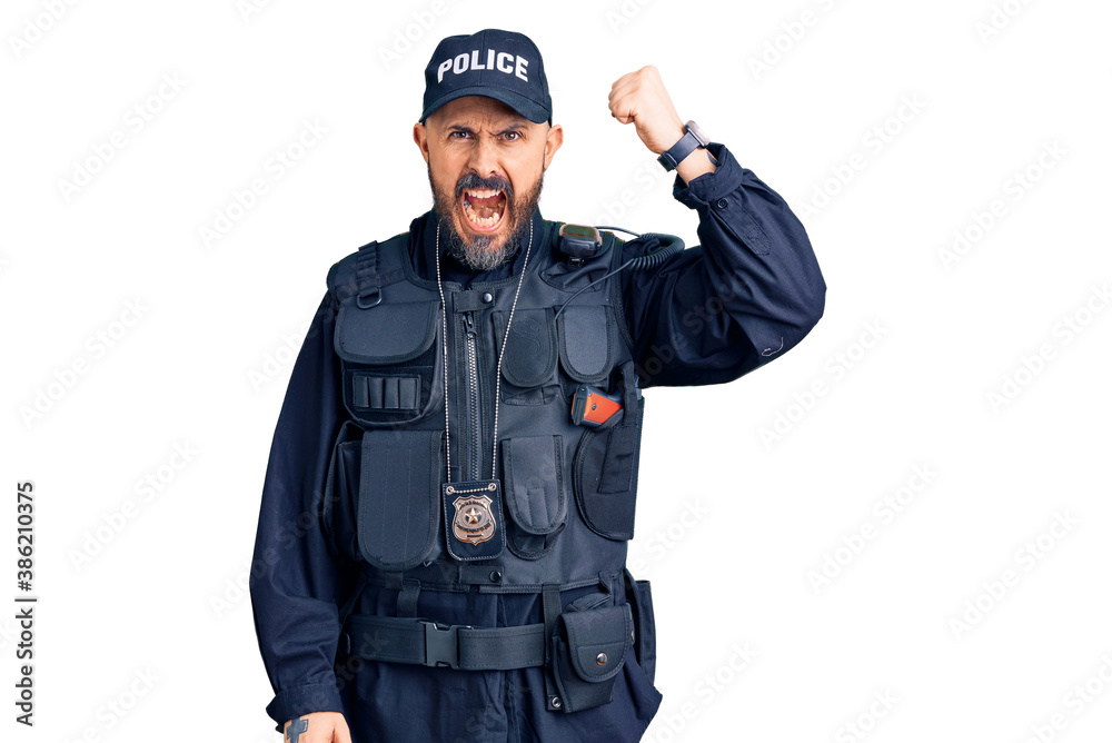 Young handsome man wearing police uniform angry and mad raising fist frustrated and furious while shouting with anger. rage and aggressive concept. Young handsome man wearing police uniform angry and mad raising fist frustrated and furious while shouting with anger. rage and aggressive concept.