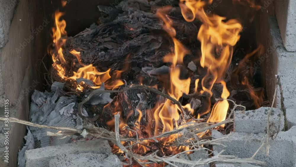 Paper and weeds burning in bonfire close up Paper and weeds burning in bonfire close up