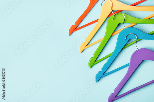 Multi-colored clothes hangers on a blue background. Concept of shopping and sale.