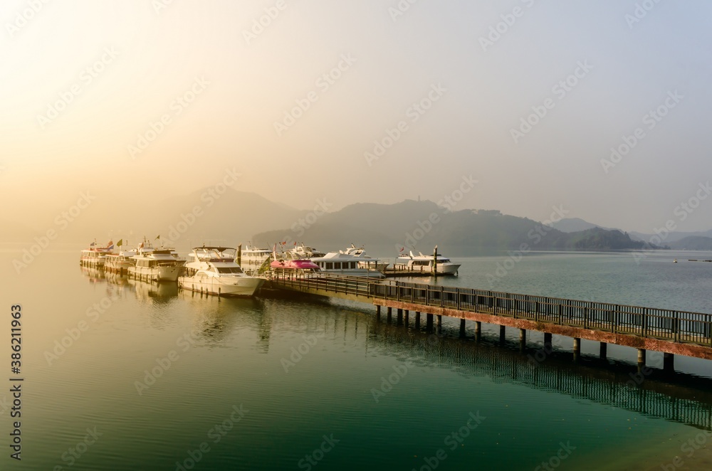 Beautiful sun rise scene of boats at pier at Sun Moon Lake, Taiw