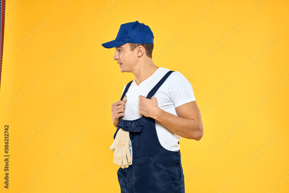 Man in working uniform emotions rendering service delivery service yellow background