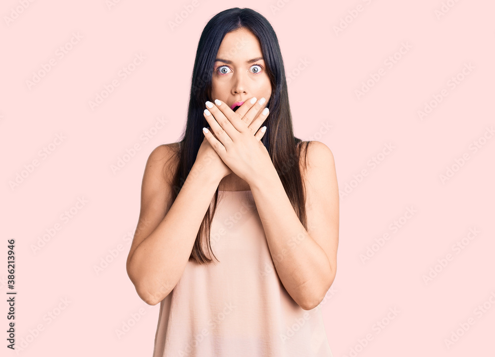Young beautiful caucasian woman wearing casual clothes shocked covering mouth with hands for mistake. secret concept. Young beautiful caucasian woman wearing casual clothes shocked covering mouth with hands for mistake. secret concept.