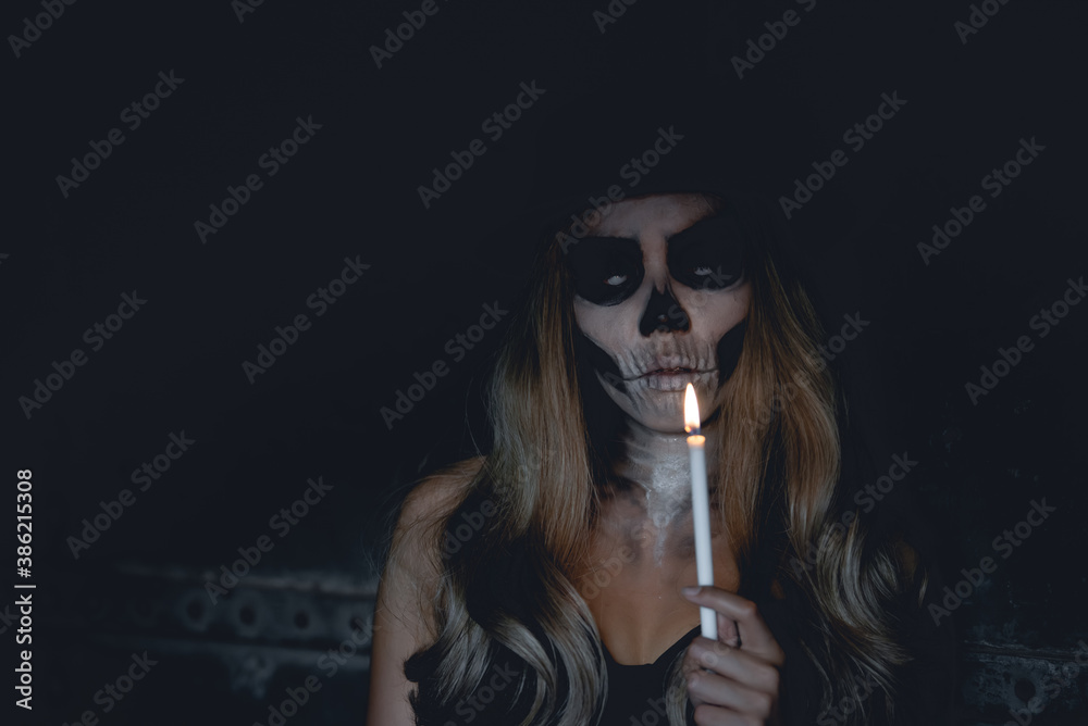 Fototapeta premium Portrait of woman make up ghost face,Mexico City’s Day of the Dead parade on Sunday honored those killed in two recent earthquakes,Thailand people,Light a candle to commemorate the people away.