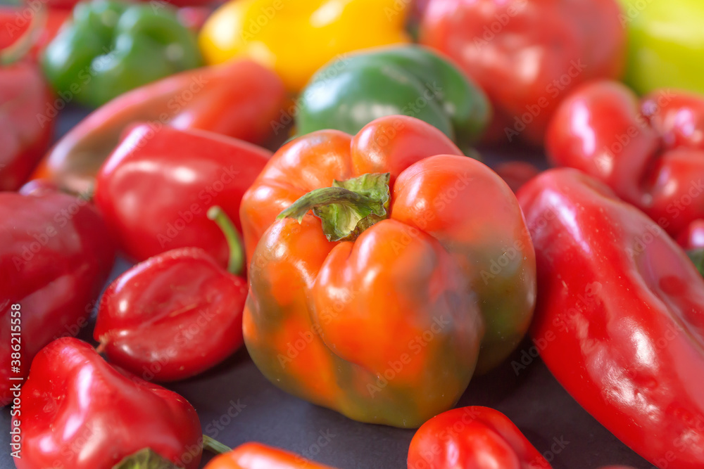 Green, yellow and red bell pepper isolated on black background, top view Green, yellow and red bell pepper isolated on black background, top view