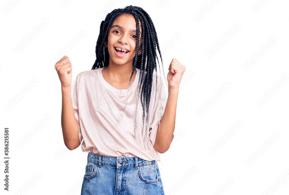 Cute african american girl wearing casual clothes screaming proud, celebrating victory and success very excited with raised arms Cute african american girl wearing casual clothes screaming proud, celebrating victory and success very excited with raised arms