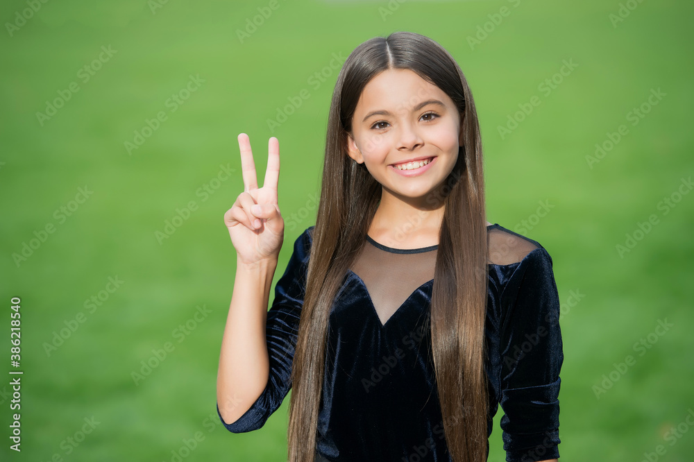Give child peaceful childhood. Happy kid show peace sign green grass. Happy childrens day. Maternity and childcare. International childrens day. Dream big little one