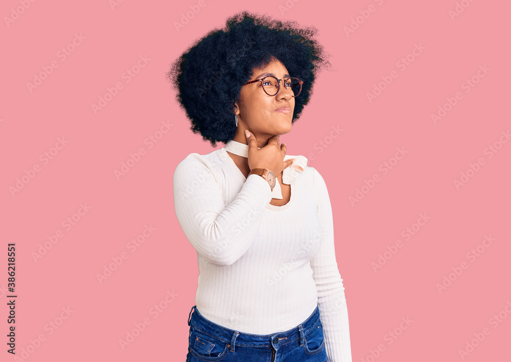 Young african american girl wearing casual clothes and glasses touching painful neck, sore throat for flu, clod and infection Young african american girl wearing casual clothes and glasses touching painful neck, sore throat for flu, clod and infection