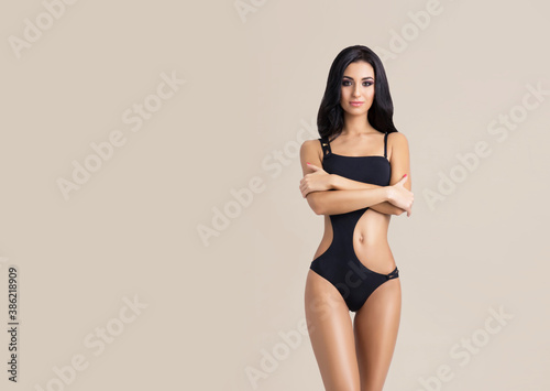 Slender and young girl with beautiful and fit body. Woman in swimsuit.
