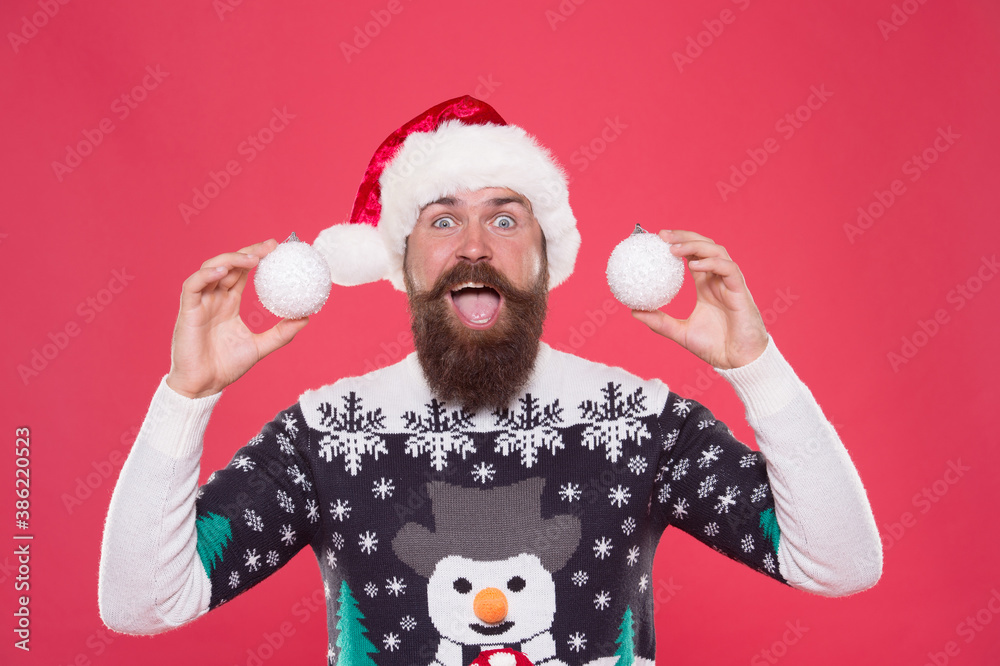 man in sweater hold decorative snowballs. xmas shopping time. tree decoration. surprised bearded man in santa hat. happy new year party fun. celebrate winter holidays. merry christmas. It is for you