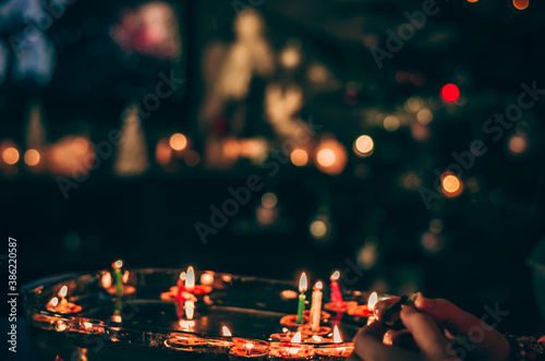 christmas traditional customs  - nut shell with burning candle floating on water photo