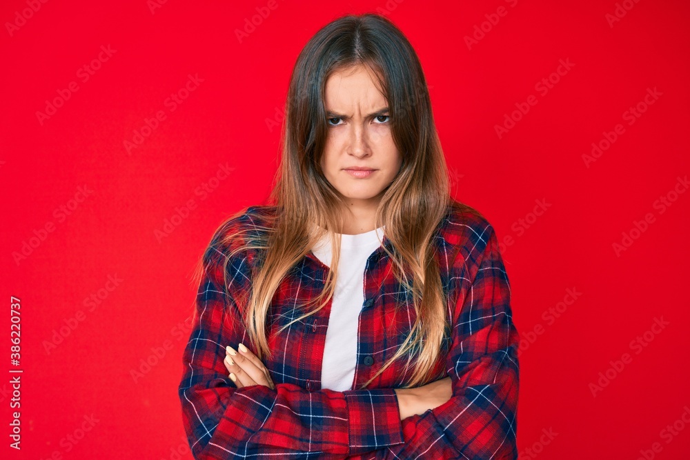Beautiful caucasian woman wearing casual clothes skeptic and nervous, disapproving expression on face with crossed arms. negative person. Beautiful caucasian woman wearing casual clothes skeptic and nervous, disapproving expression on face with crossed arms. negative person.