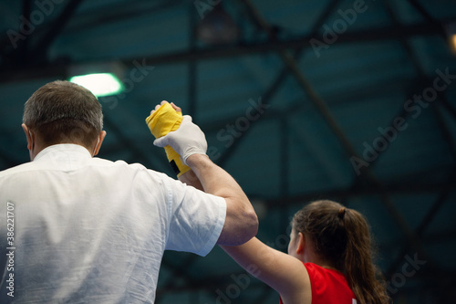 Boxing judge raised girl hand up when announcing a winner in a competition