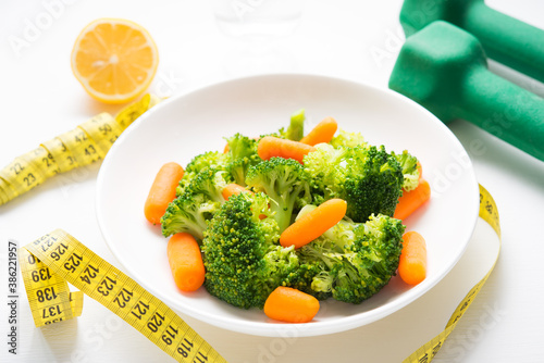A plate of diet food, boiled vegetables, broccoli and carrots, fitness nutrition