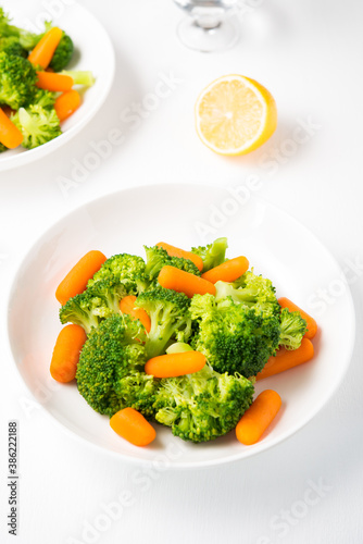 A plate of diet food, boiled vegetables, broccoli and carrots, fitness nutrition