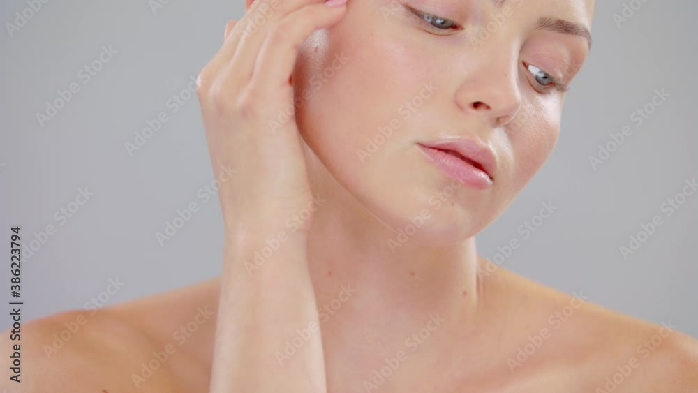 Close Up Beautiful Young Caucasian Blonde Woman With Blue Eyes And Smooth Healthy Skin Touches His Face With Hand Skin Care Cosmetic Concept Slow Motion On Grey Background Close Up Beautiful Young Caucasian Blonde Woman With Blue Eyes And Smooth Healthy Skin Touches His Face With Hand Skin Care Cosmetic Concept Slow Motion On Grey Background