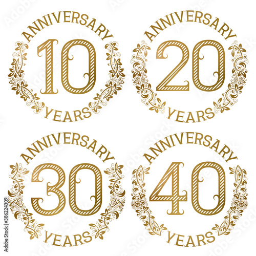 Set of golden anniversary emblems. Tenth, twentieth, thirtieth, fortieth years signs in vintage style.