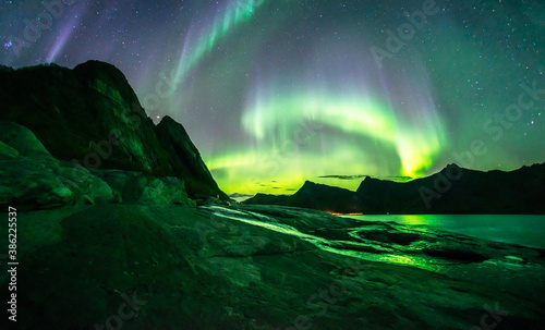Bild auf Leinwand Amazing auroras storm above Rocks of Tungeneset Viewpoint, Senja, Norway