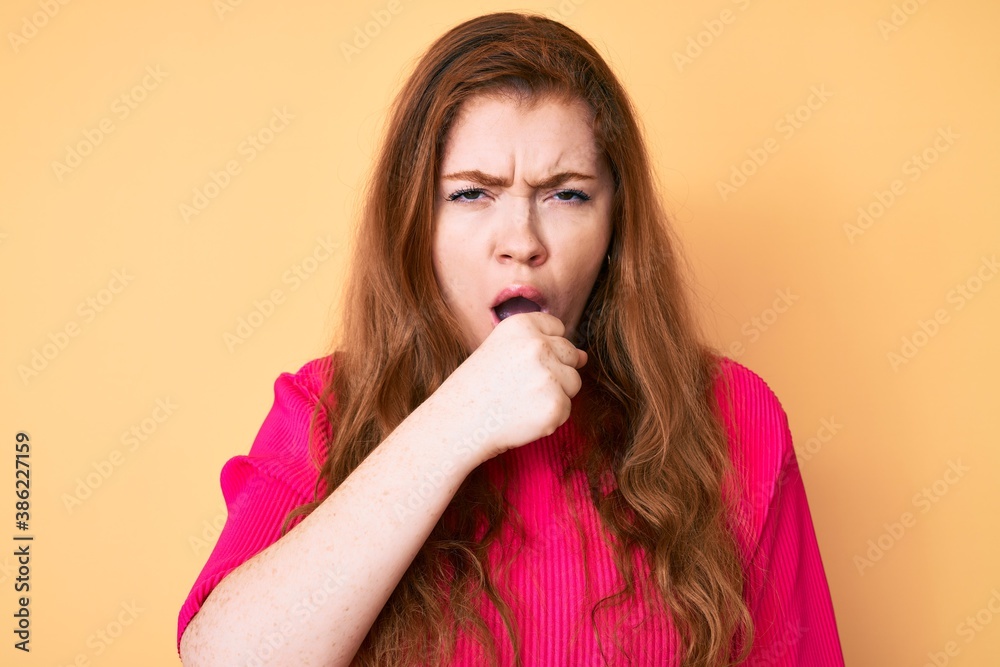 Young redhead woman wearing casual clothes feeling unwell and coughing as symptom for cold or bronchitis. health care concept.