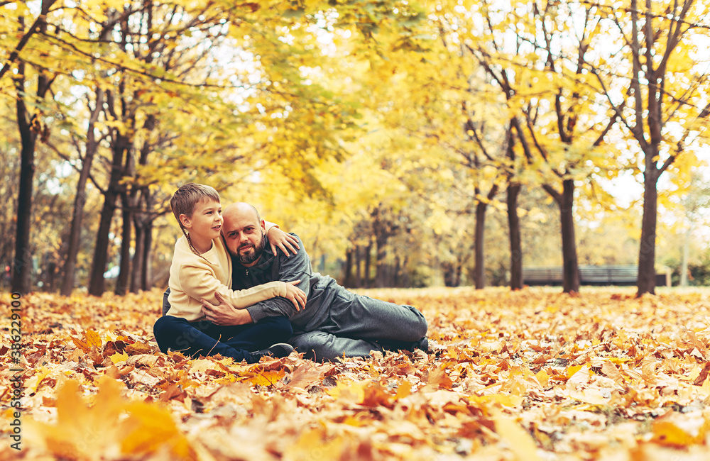 father and son in the autumn Park spend time together father and son in the autumn Park spend time together