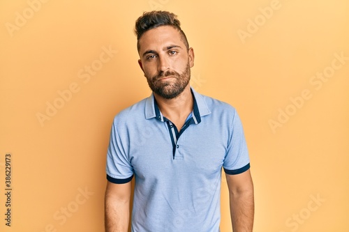 Handsome man with beard wearing casual clothes depressed and worry for distress, crying angry and afraid. sad expression.