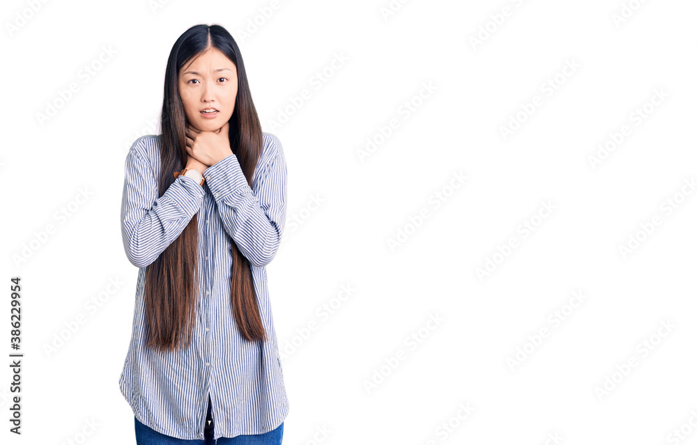 Young beautiful chinese woman wearing casual shirt shouting and suffocate because painful strangle. health problem. asphyxiate and suicide concept. Young beautiful chinese woman wearing casual shirt shouting and suffocate because painful strangle. health problem. asphyxiate and suicide concept.